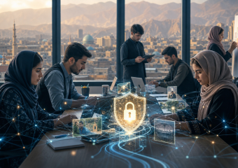 Team collaborating around a glowing digital shield and padlock, symbolizing cybersecurity, with a mountain city visible through windows