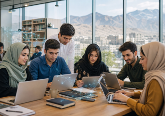 Six people collaborating on laptops around a conference table in a modern office overlooking a city and mountains